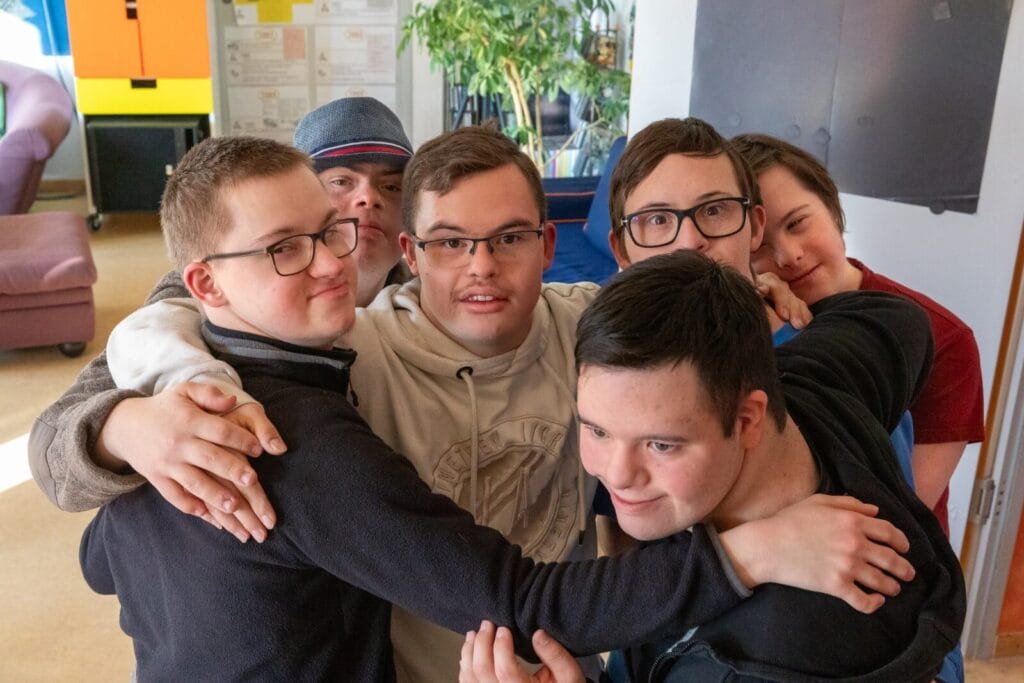 Mitglieder der einsmehr Jungsgruppe umarmen sich